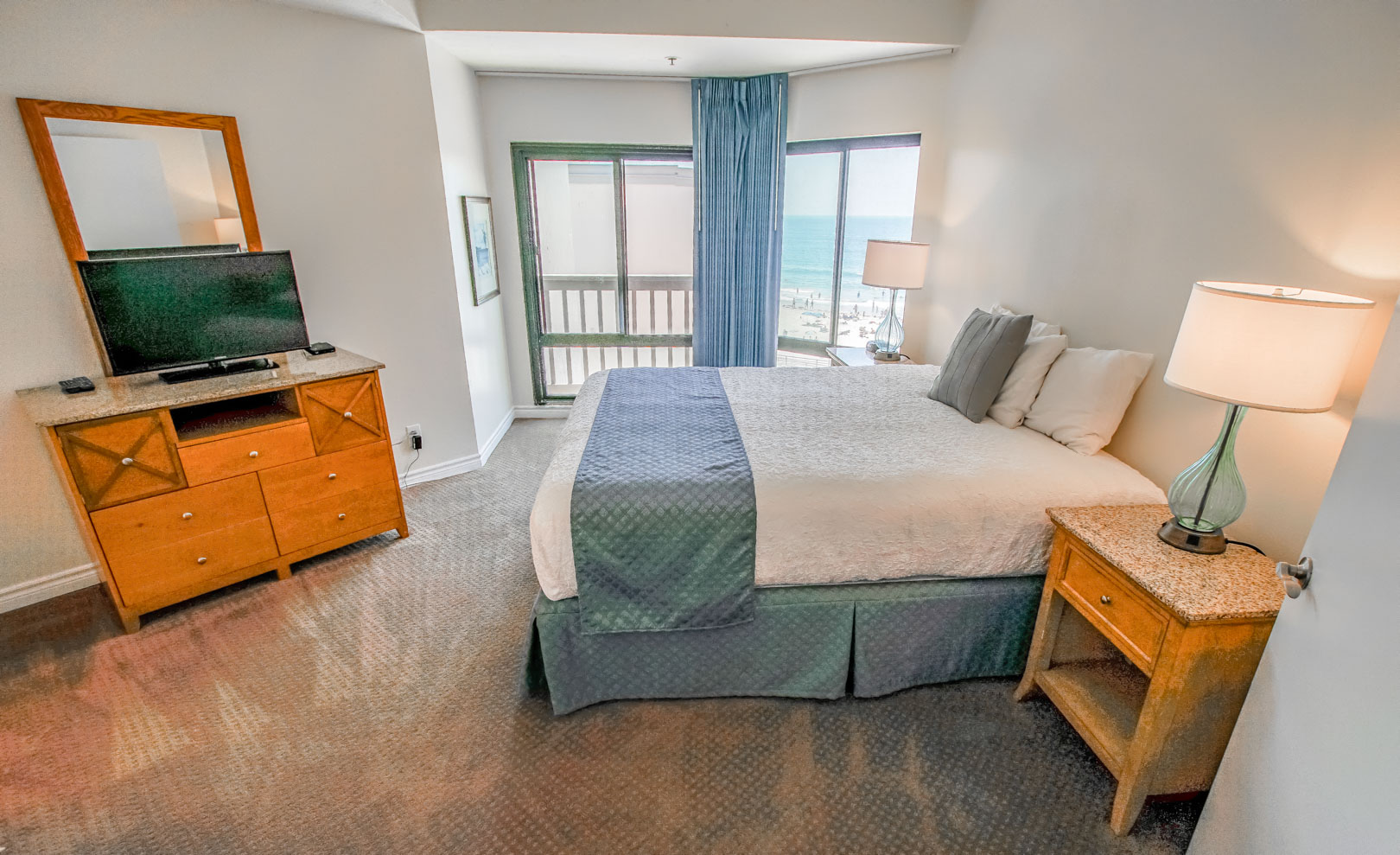 An airy master bedroom with a view overlooking the beach at VRI's See the Sea in San Diego, CA.